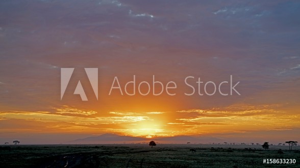 Picture of Sun rising through rain clouds in Serengeti Tanzania